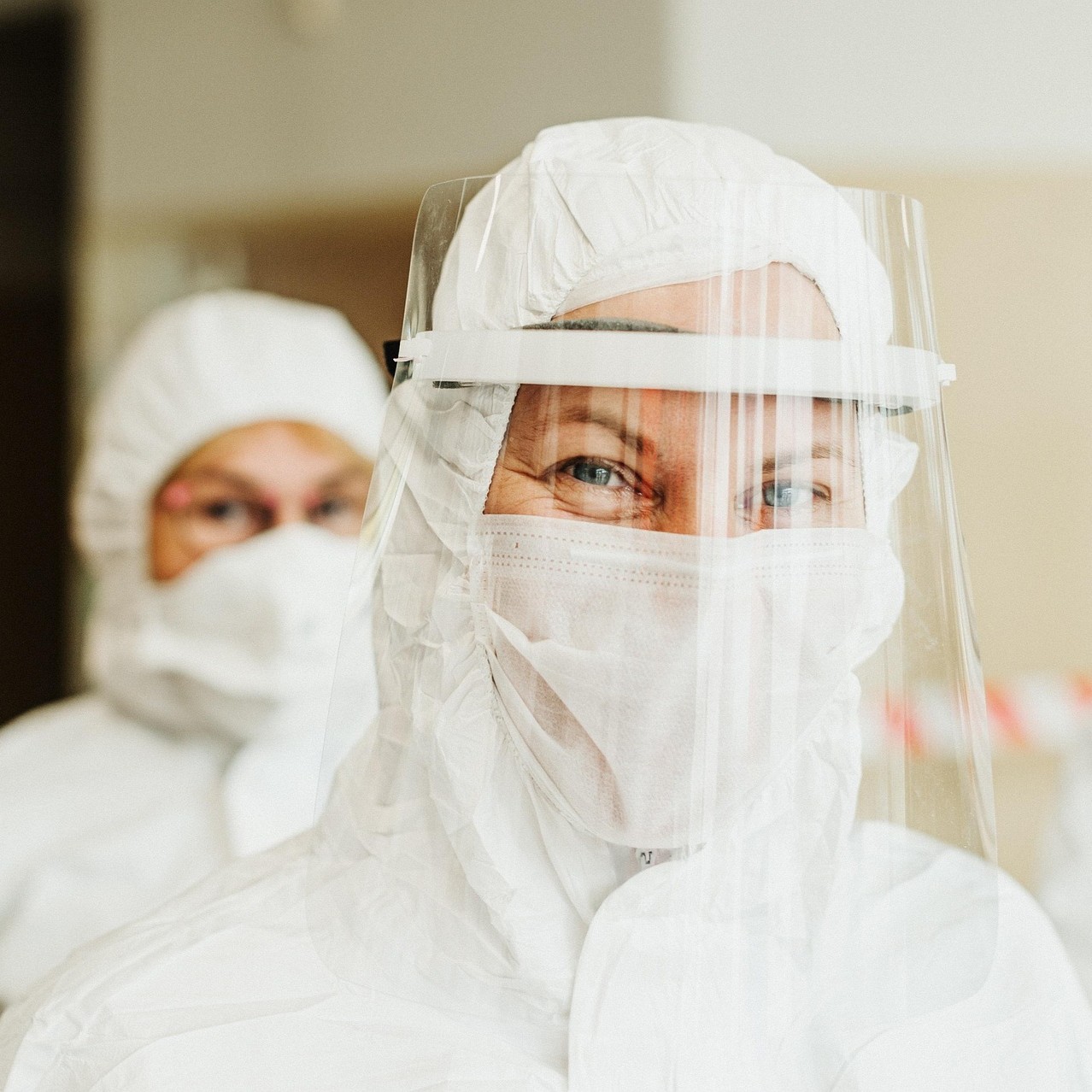 people wearing protective suits